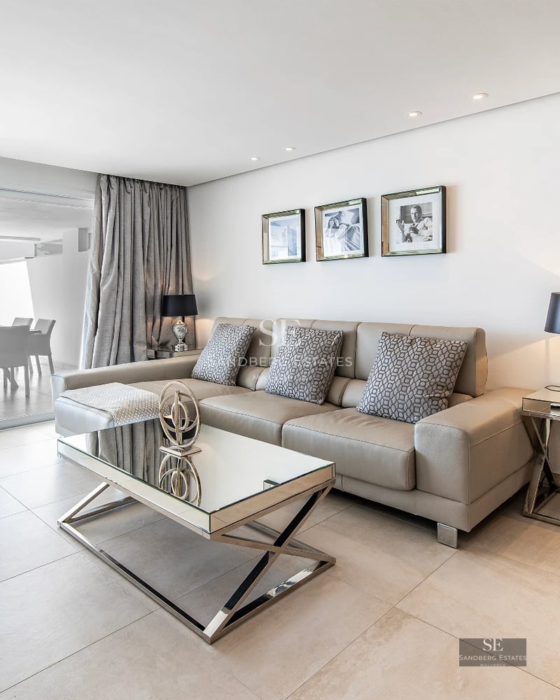 Exterior view of a modern villa with reflecting pool. Minimalist design, large windows, and lush gardens.