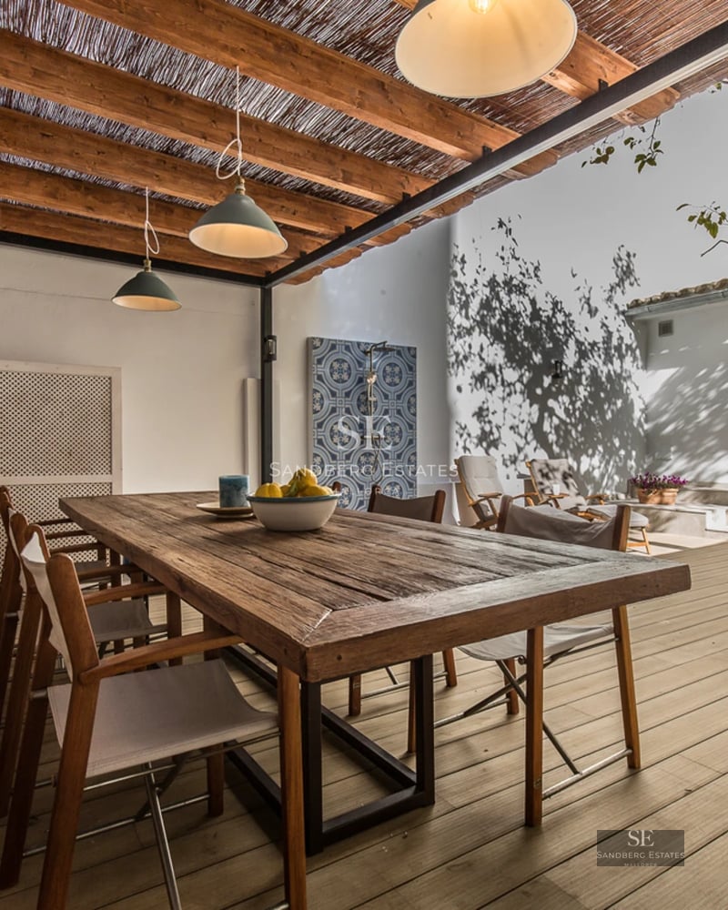 Spacious living room with panoramic sea view windows, modern sofas, warm lighting, and elegant minimalist decor.