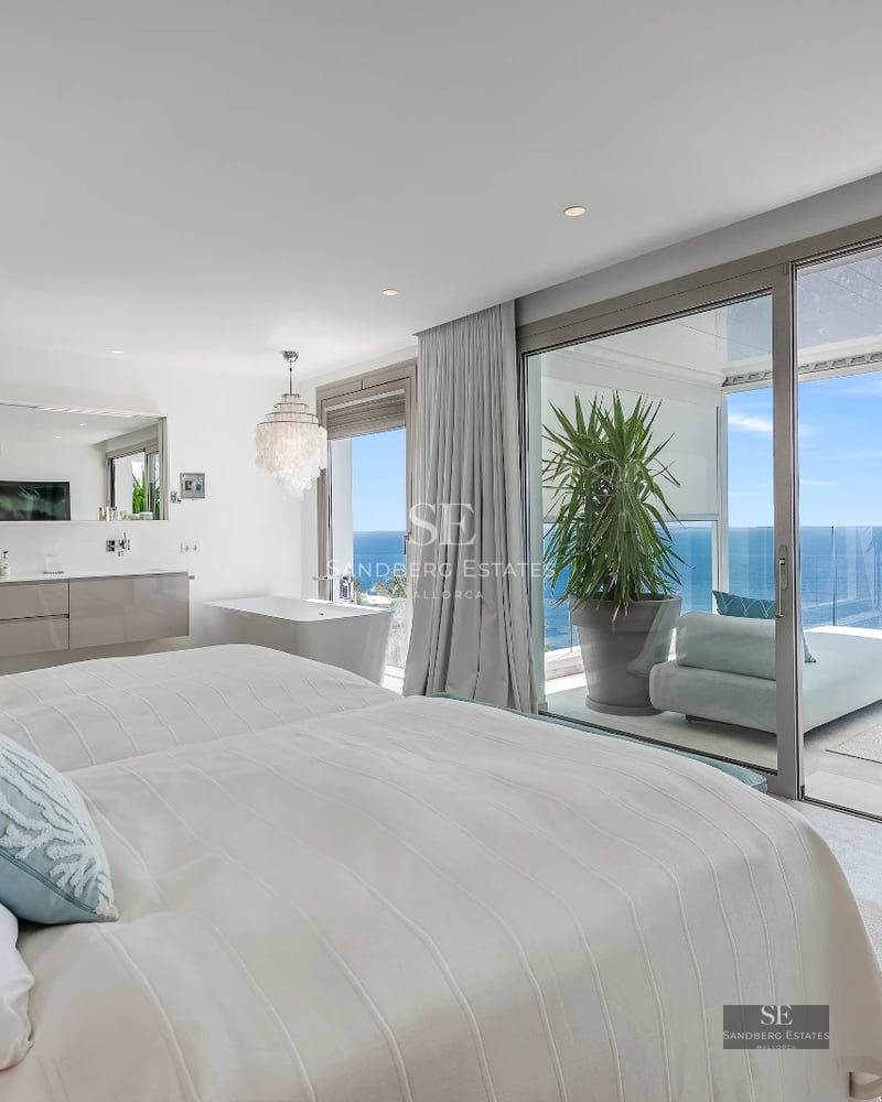 Spacious terrace with infinity pool and sea views. Modern design, glass railing and elegant furniture.