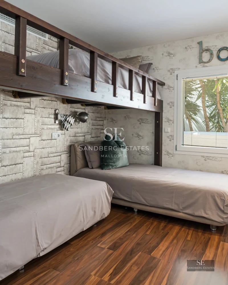 Exterior view of a modern villa featuring a swimming pool, landscaped garden, and expansive outdoor living spaces.