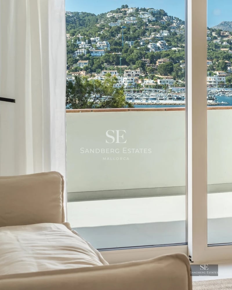Exterior view of a modern villa with a pool, palm trees, and large glass windows. Minimalist architecture. Warm lighting.