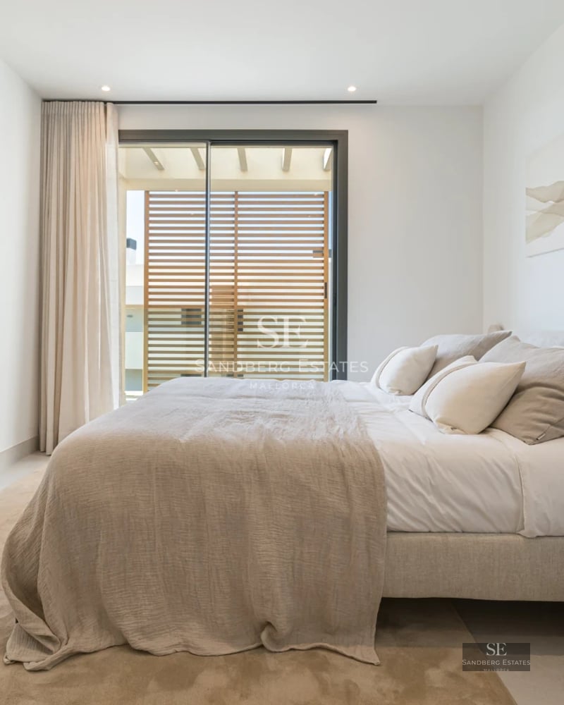 Bright living room with balcony and sea view. Modern design, wooden floors, and elegant furniture. Ideal for investment.