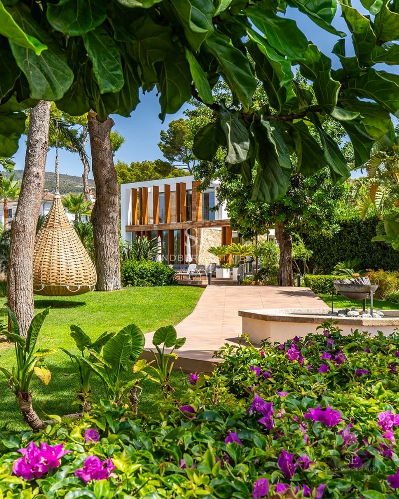 Spacious balcony with glass railing, panoramic views, outdoor furniture. Modern and elegant design with ambient lighting.