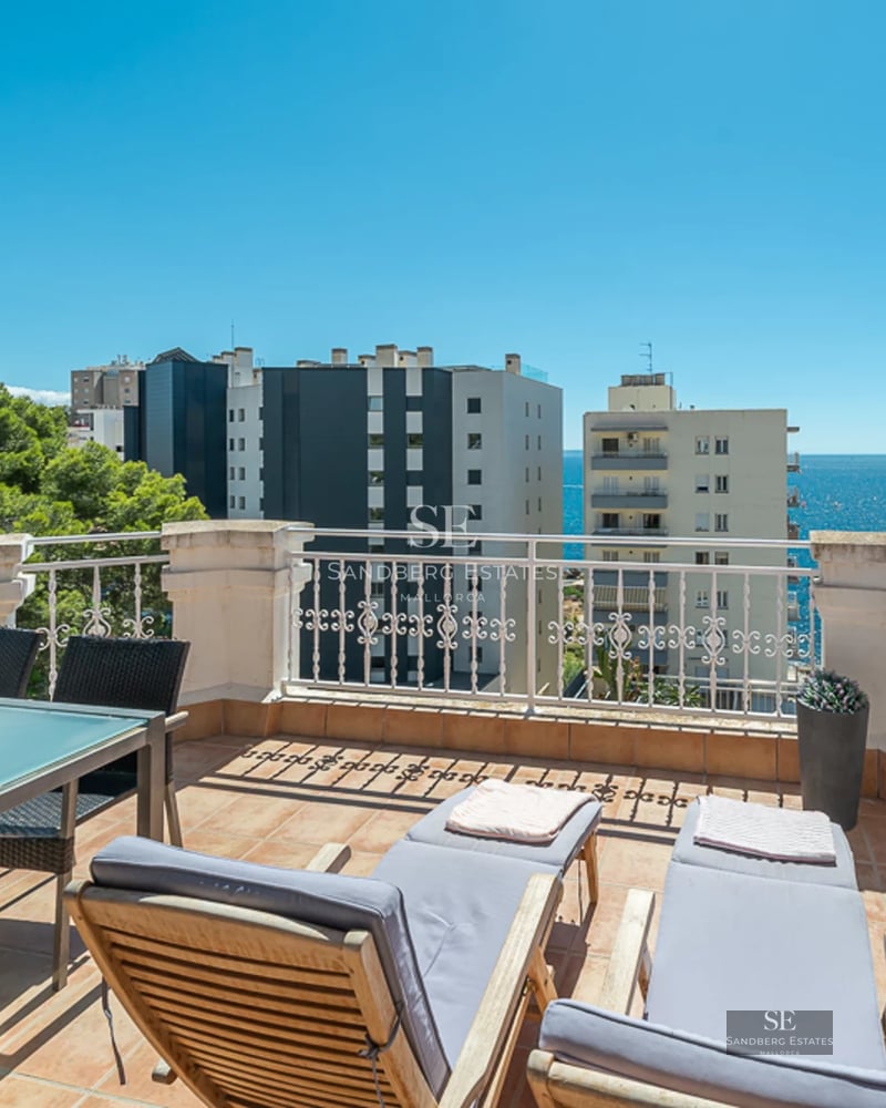 Expansive turquoise pool surrounded by lush greenery and a modern house with large windows. Relaxation and luxury.