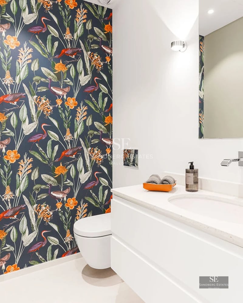 View of infinity pool with modern home. Large windows, elegant design and lush natural surroundings. Ideal for relaxation and luxury.