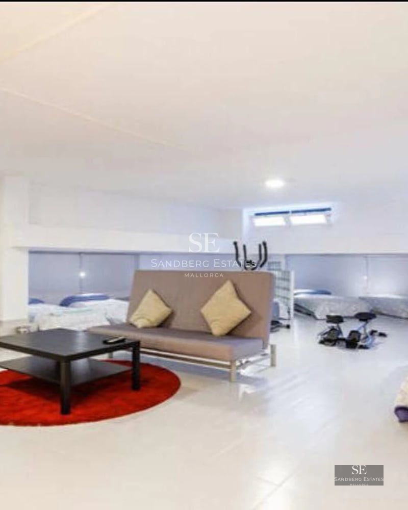 Spacious living room with panoramic windows, sea views, modern and elegant furniture, and abundant natural light.