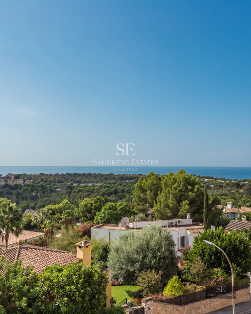 Spacious living room with floor-to-ceiling windows overlooking the sea, modern furniture, natural light, and neutral color palette. Sleek, minimalist design.