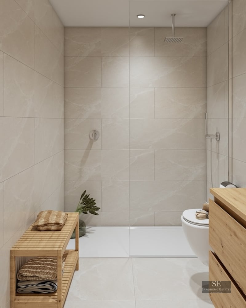Bathroom with beige marble tiles, walk-in glass shower, wooden vanity with vessel sink, and backlit circular mirror.