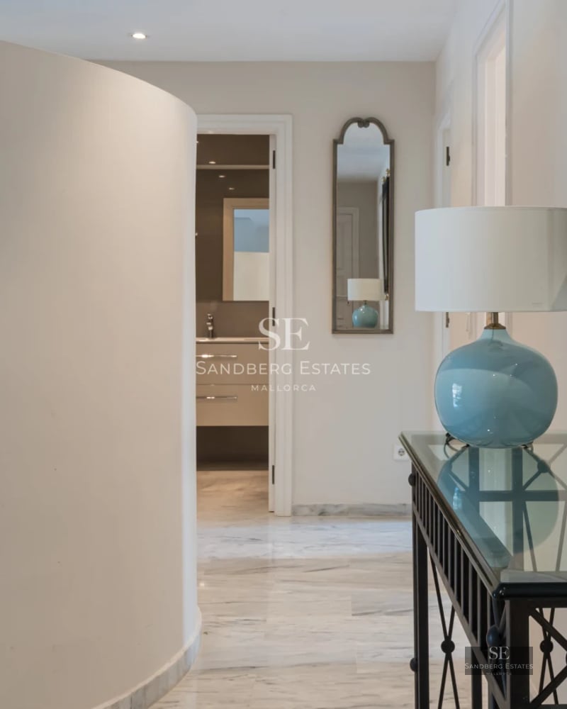 Exterior of modern villa with reflecting pool, lush garden, and minimalist architecture. Warm ambient lighting.