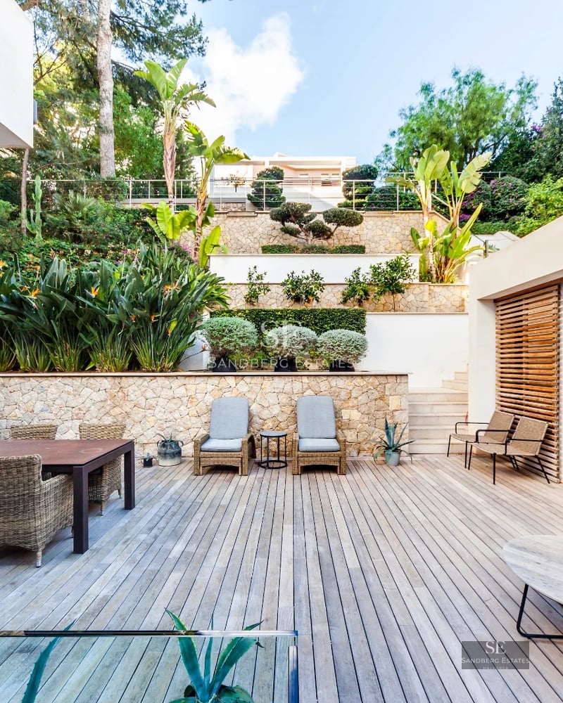 Spacious living room with floor-to-ceiling windows, sea view, modern design, natural light, and high-end furniture. Ideal real estate investment.