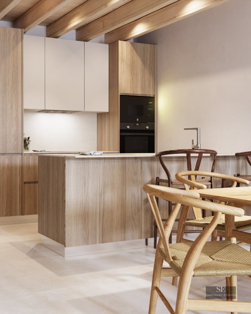 Modern kitchen featuring exposed wooden ceiling beams, a central island with stools, and an adjacent wooden dining table.