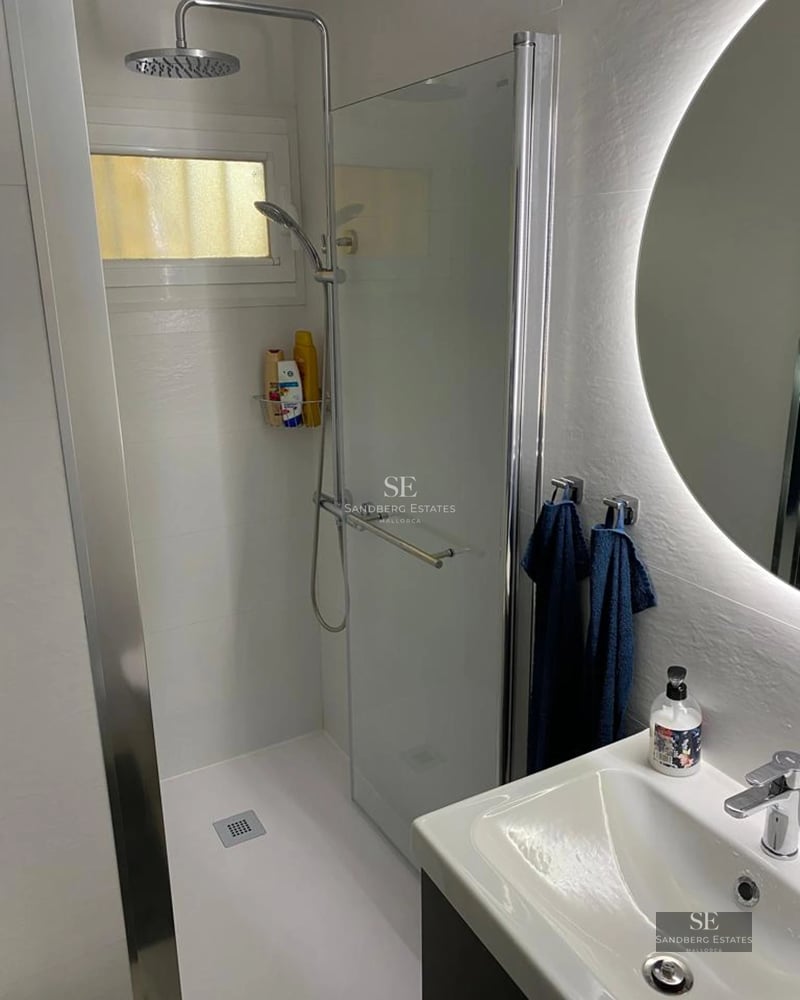 Expansive terrace with infinity pool, sun loungers, and panoramic views. Modern design with glass railings and lush vegetation.