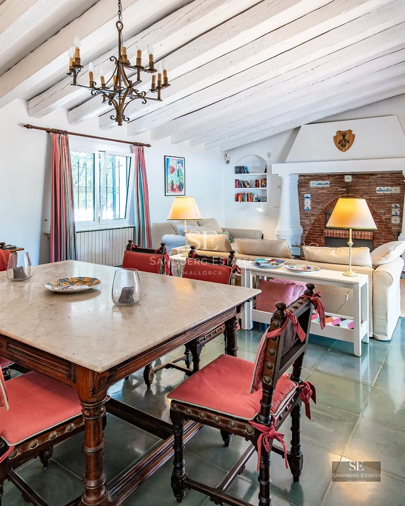 View of infinity pool with lush garden. Modern architecture with large windows and elegant landscaping design.