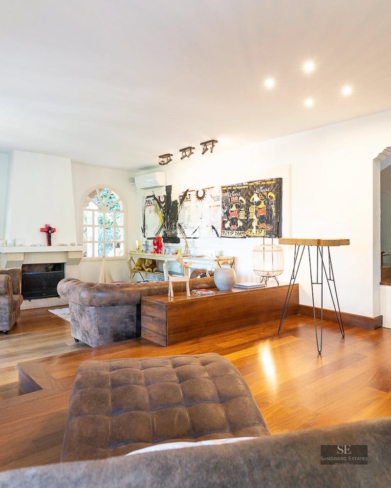 Spacious living room featuring floor-to-ceiling windows, panoramic sea views, modern and elegant furniture, and abundant natural light.