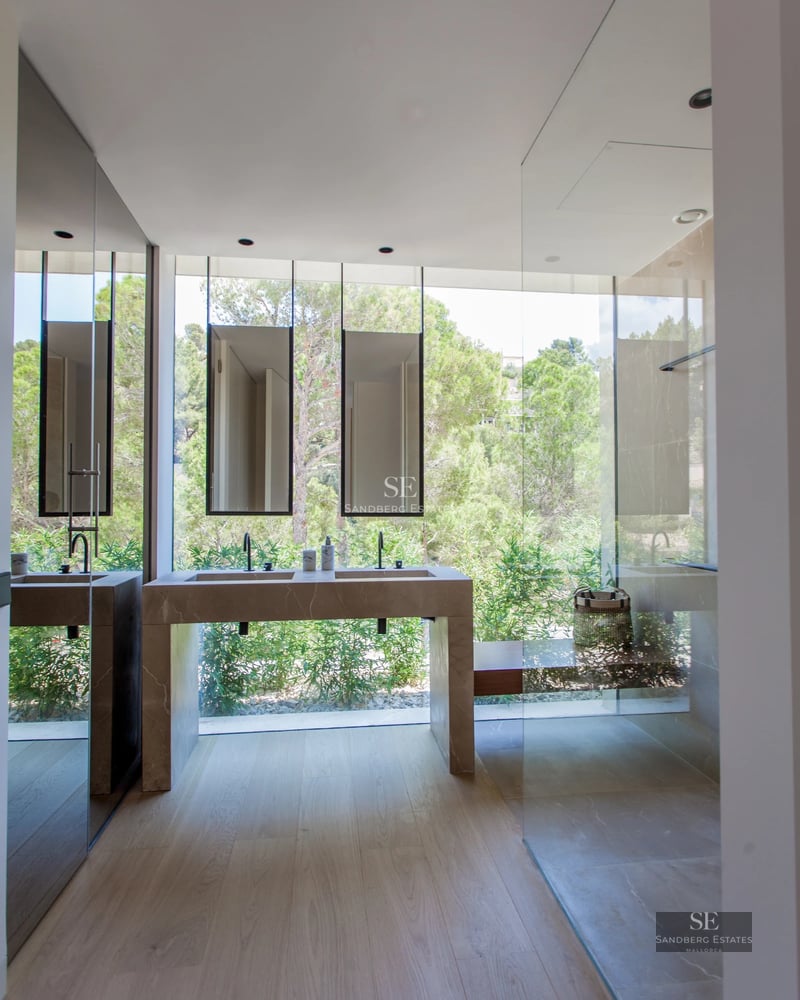 Modern villa with minimalist facade, reflecting pool, large garden and clear blue sky. Contemporary architecture.