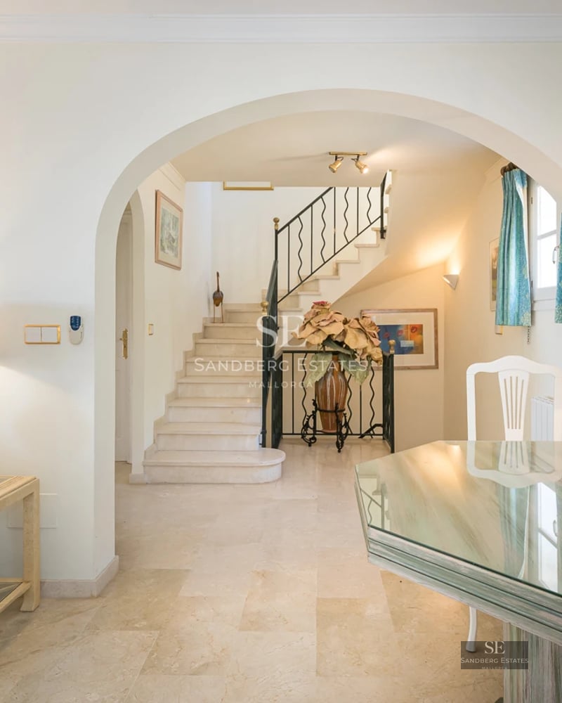 Exterior view of a modern villa with infinity pool, surrounded by greenery. Minimalist architecture with large windows.