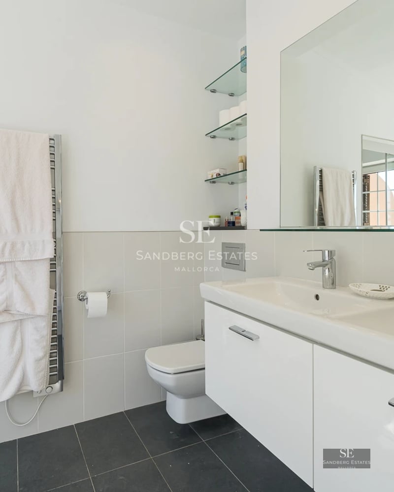 Spacious living room with floor-to-ceiling windows, modern fireplace, and designer furniture. Panoramic views. Abundant natural light.