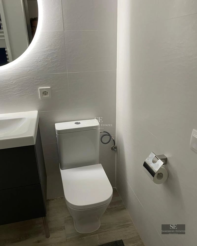 Exterior view of modern home with reflecting pool, lush garden and minimalist architecture. Soft lighting enhances the details.