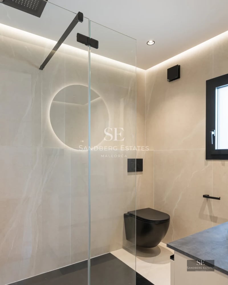 Exterior view of a modern villa featuring an infinity pool, lush garden, and natural stone facade. Minimalist architecture and expansive glass windows.