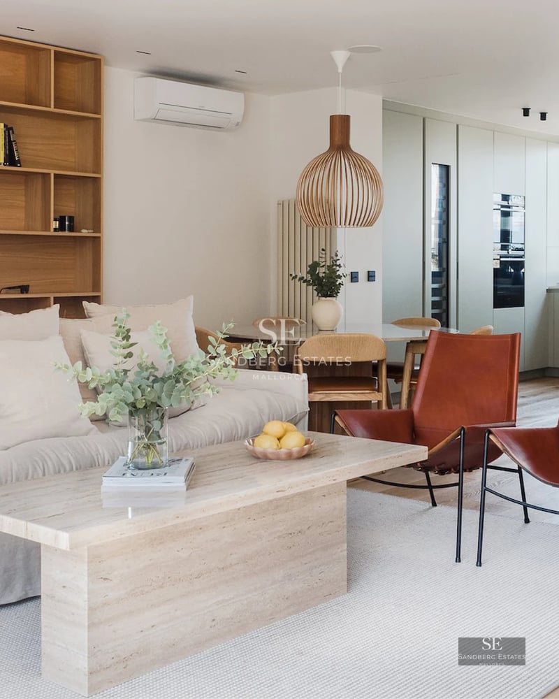 View of a modern villa with an infinity pool, lush garden, and large windows offering panoramic views.