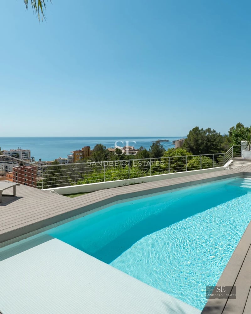 Exterior view of modern villa with pool. Minimalist architecture, large windows and lush landscaping. Ambient lighting.