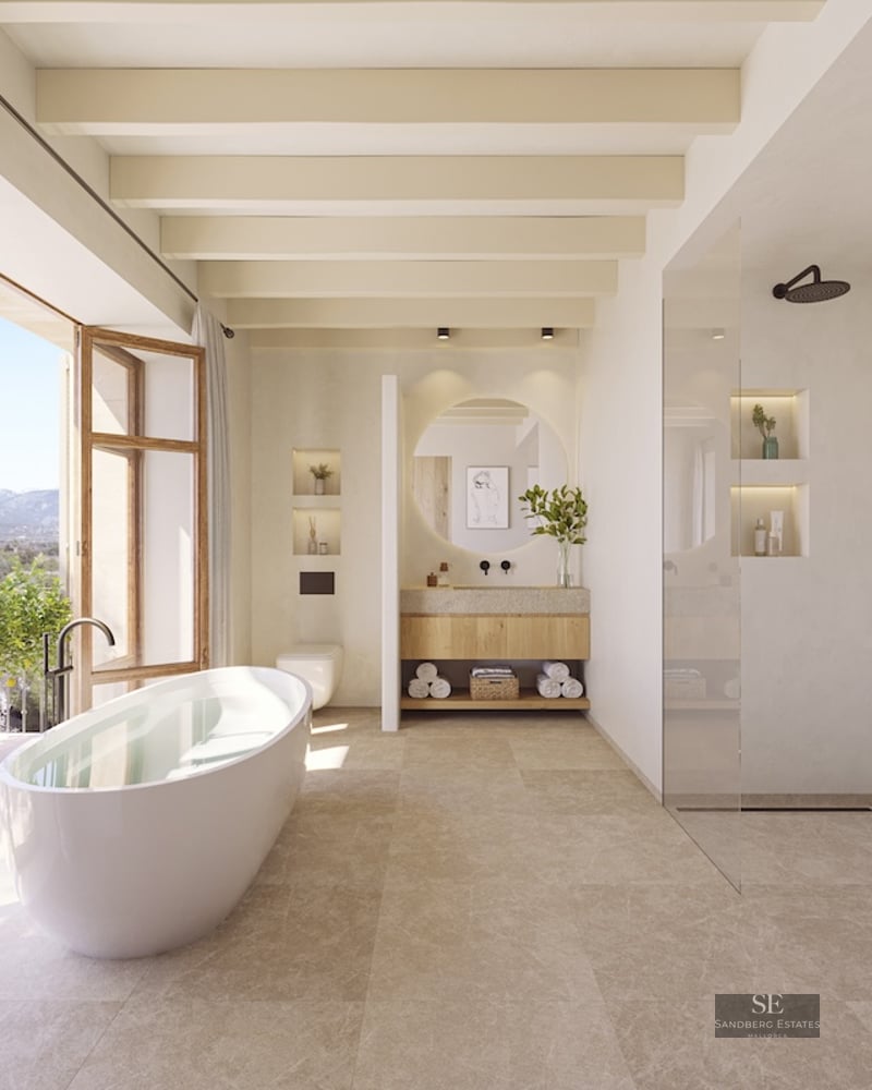 Modern bathroom featuring a freestanding tub, glass shower, and large windows opening to a mountain landscape.