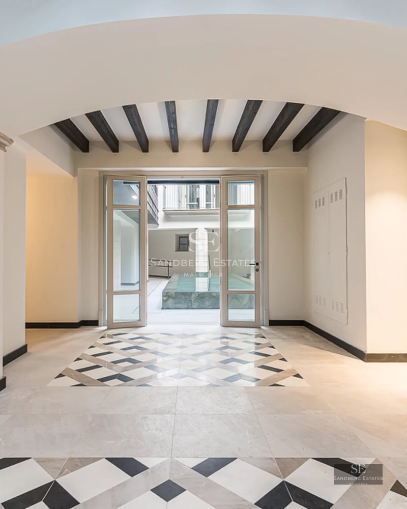 View of a modern villa with a pool, surrounded by greenery. Sleek design, high-quality finishes, and abundant natural light.