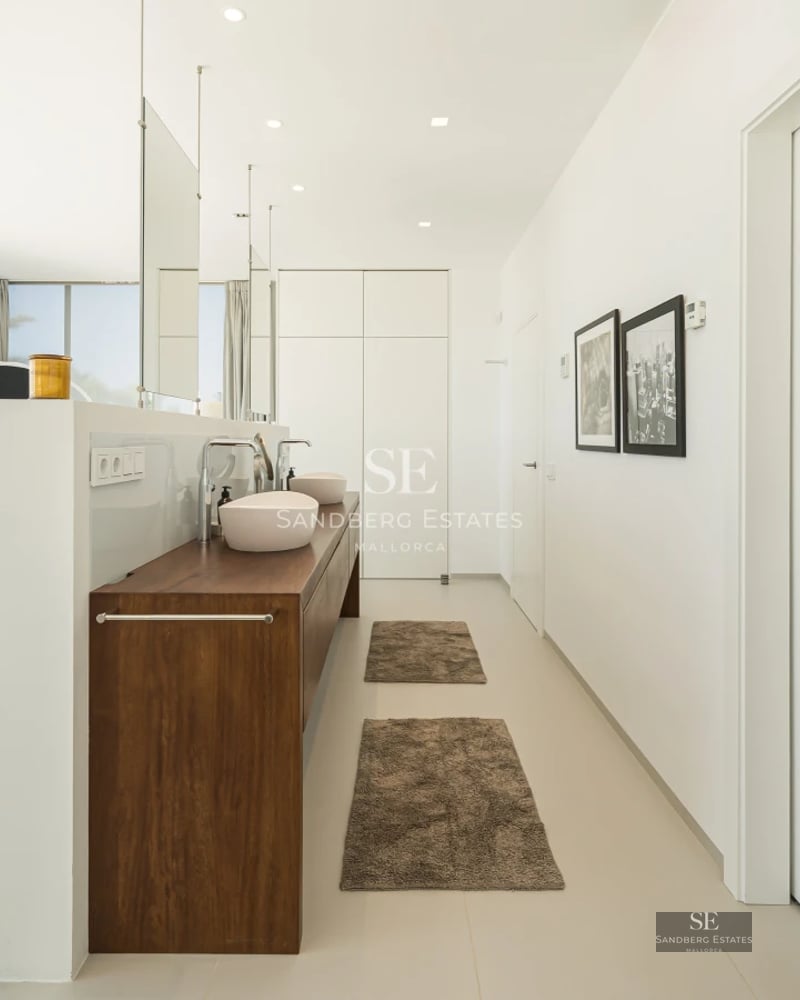 Exterior view of a modern villa with pool, lush gardens, and contemporary architecture.