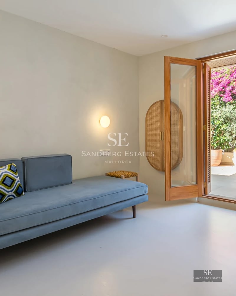 Exterior view of a modern villa featuring an infinity pool, lush garden, and expansive terraces. Minimalist architectural design.