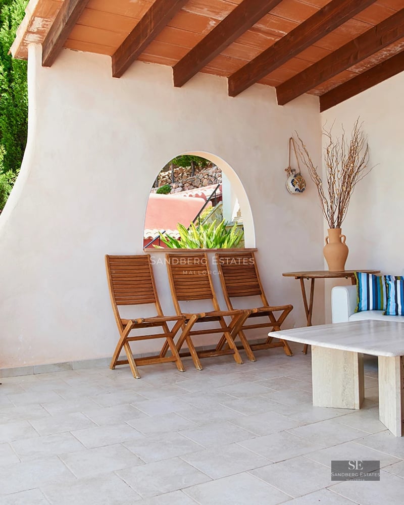 View of a luxury apartment with pool, furnished terrace and modern design. Bright interior with large windows.