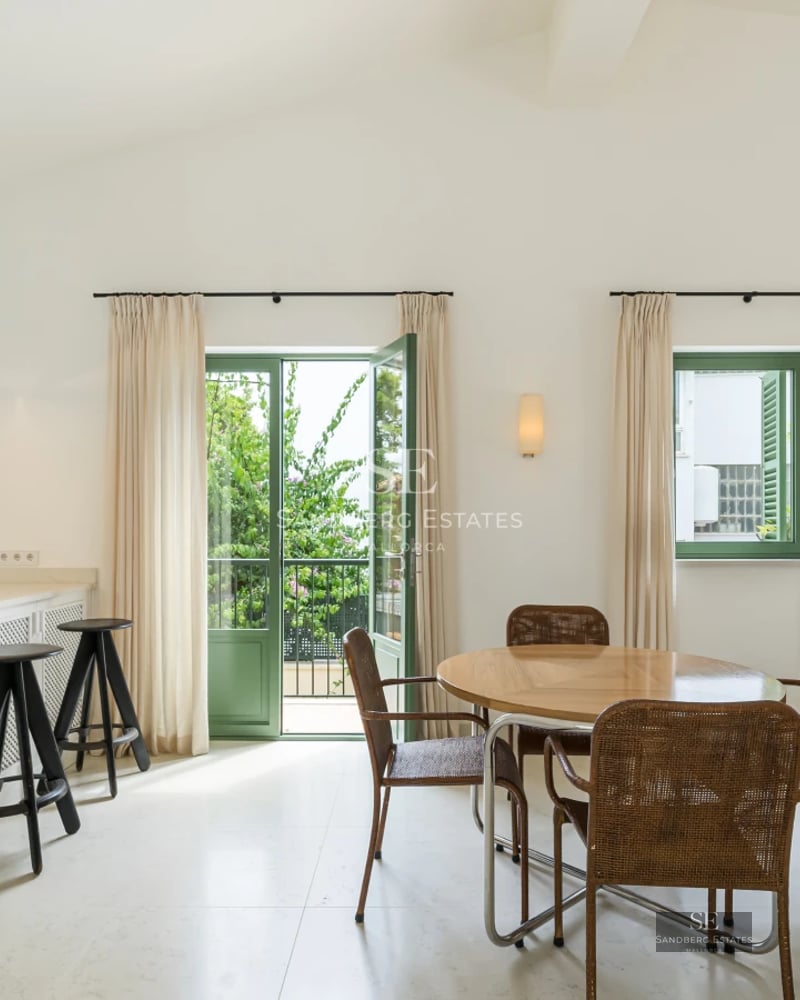 Spacious balcony with ocean view. Wooden floors, glass railing. Modern and elegant design. Soft ambient lighting.