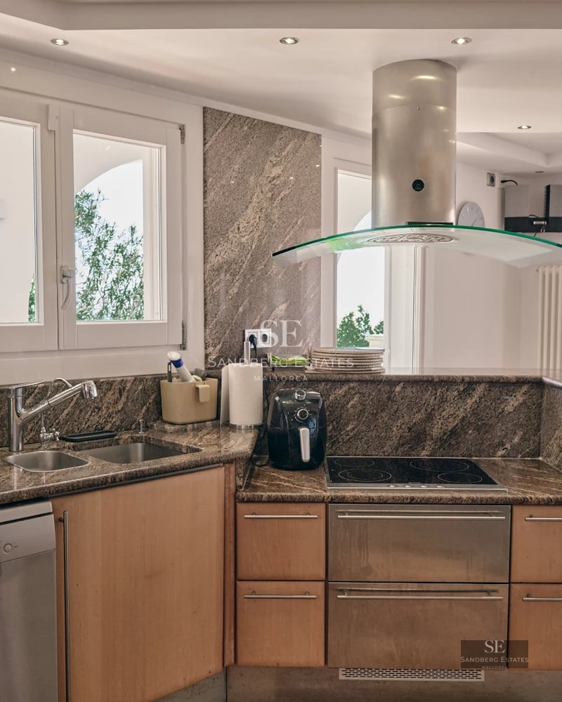 Image of a villa with a pool. Modern design featuring large windows, terrace, garden and lush vegetation. Ideal for luxury living.