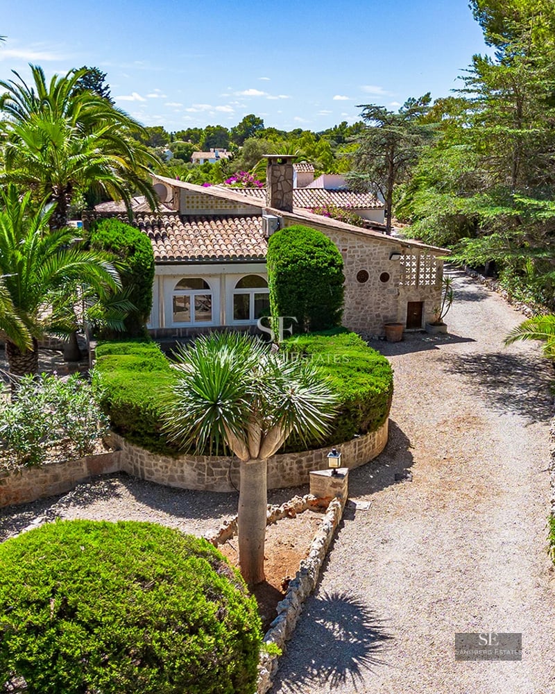 Modern exterior view. Minimalist architecture, reflecting pool, large windows. Lush garden. Warm lighting.