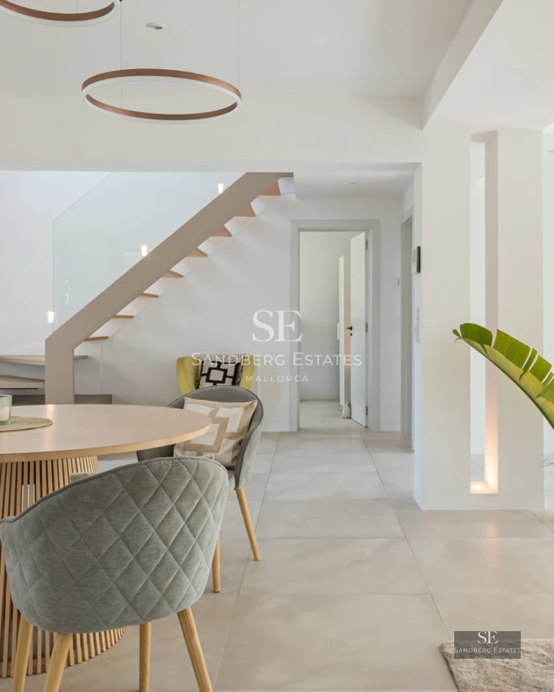 Spacious terrace with infinity pool, sea view, modern furniture, and minimalist design. Soft ambient lighting.