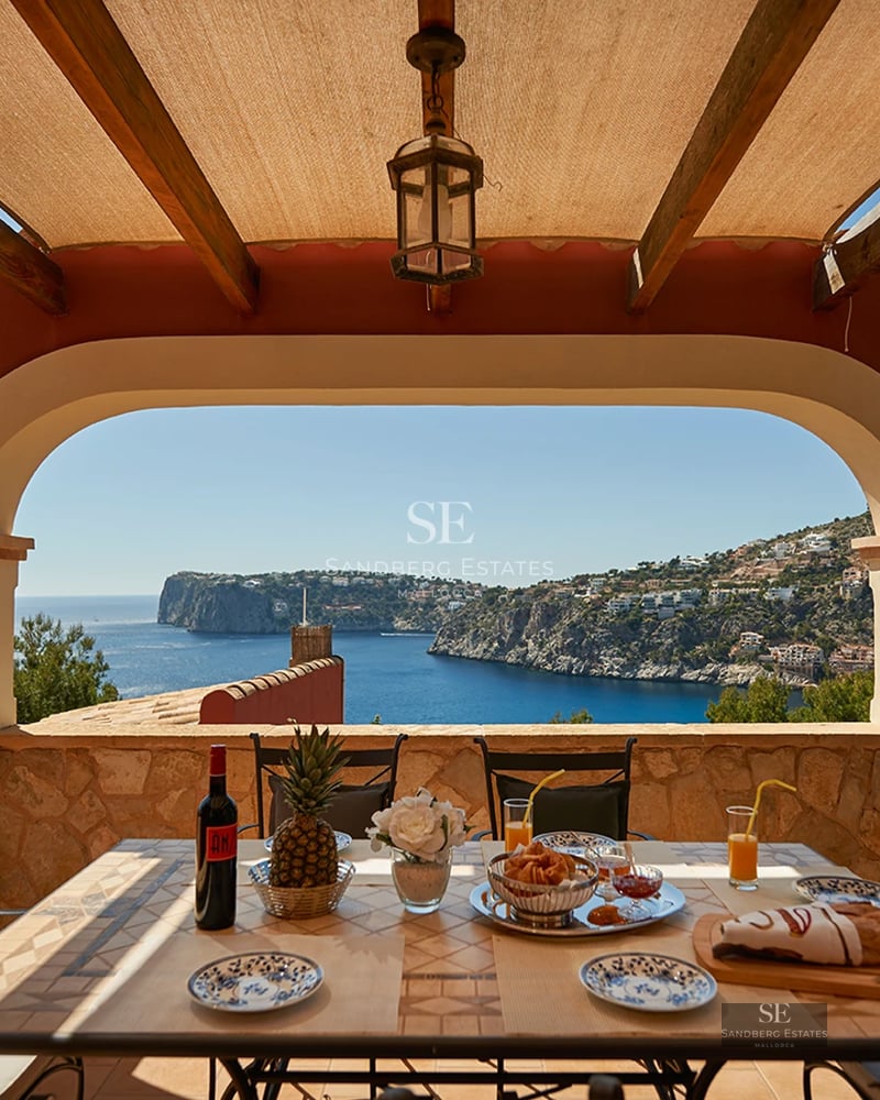 Bright living room featuring expansive windows with panoramic sea views. Modern design with elegant furniture and neutral color palette.