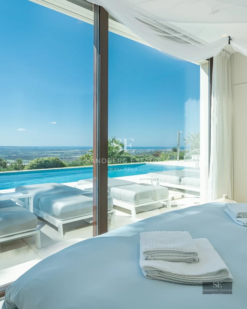 Exterior view of a modern villa with an infinity pool, large windows, and lush garden. Contemporary architecture and elegant design.