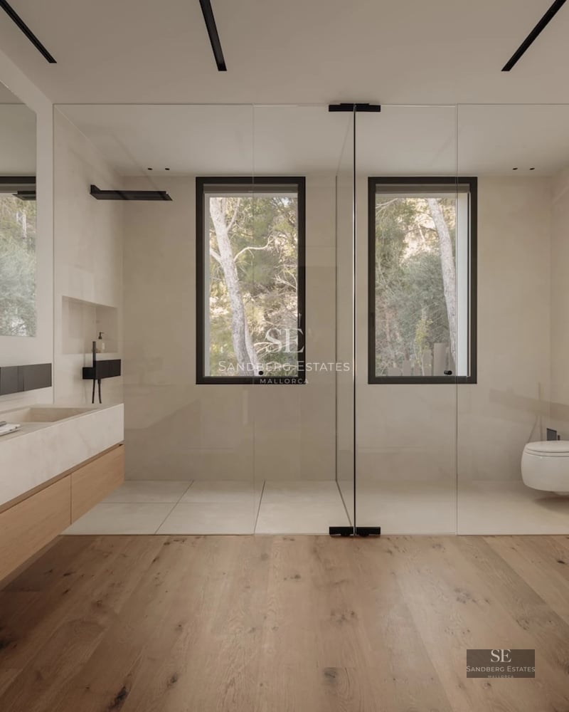 Modern facade with reflecting pool and large window front. Minimalist architecture, luxurious finishes. Soft ambient lighting.