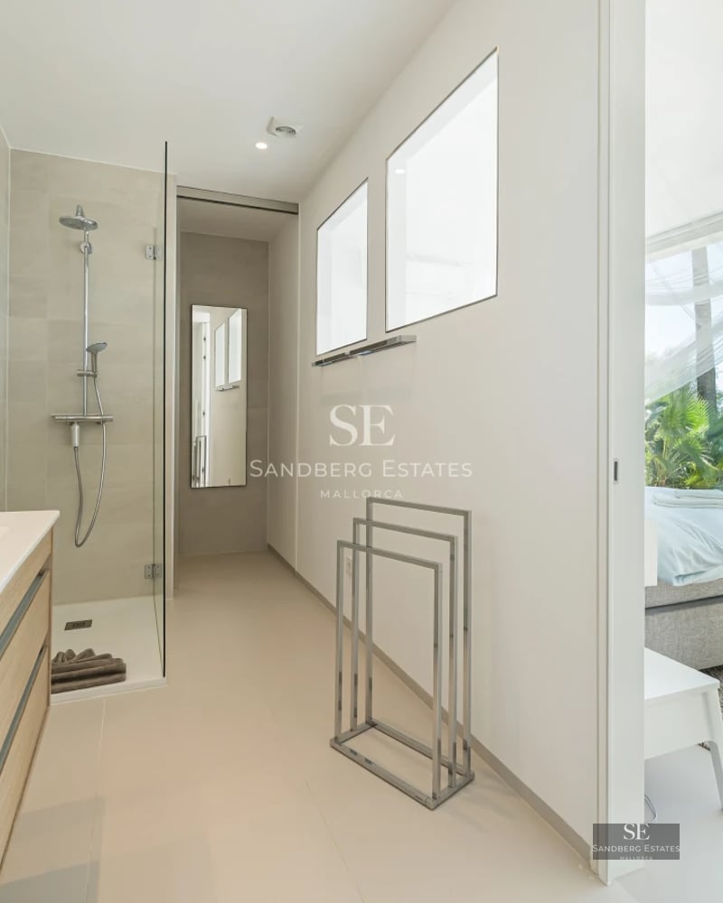 Modern balcony with glass railing, stunning view, stylish outdoor furniture, and wooden flooring. Minimalist and bright design.