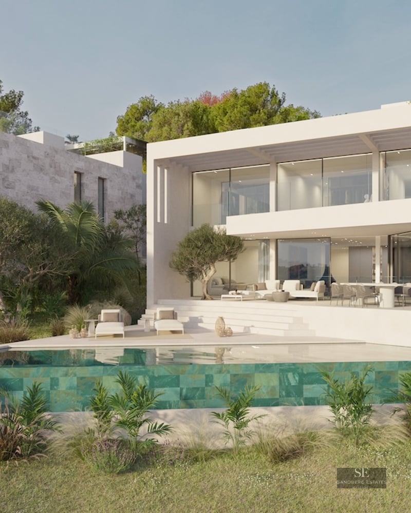 Modern two-story white villa with an infinity pool, glass balconies, and lush Mediterranean landscaping.