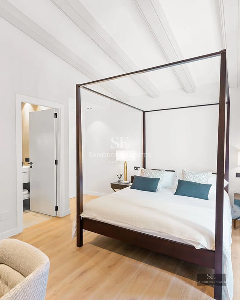 Exterior view of a modern villa with an infinity pool, manicured lawn, minimalist design, and large windows.