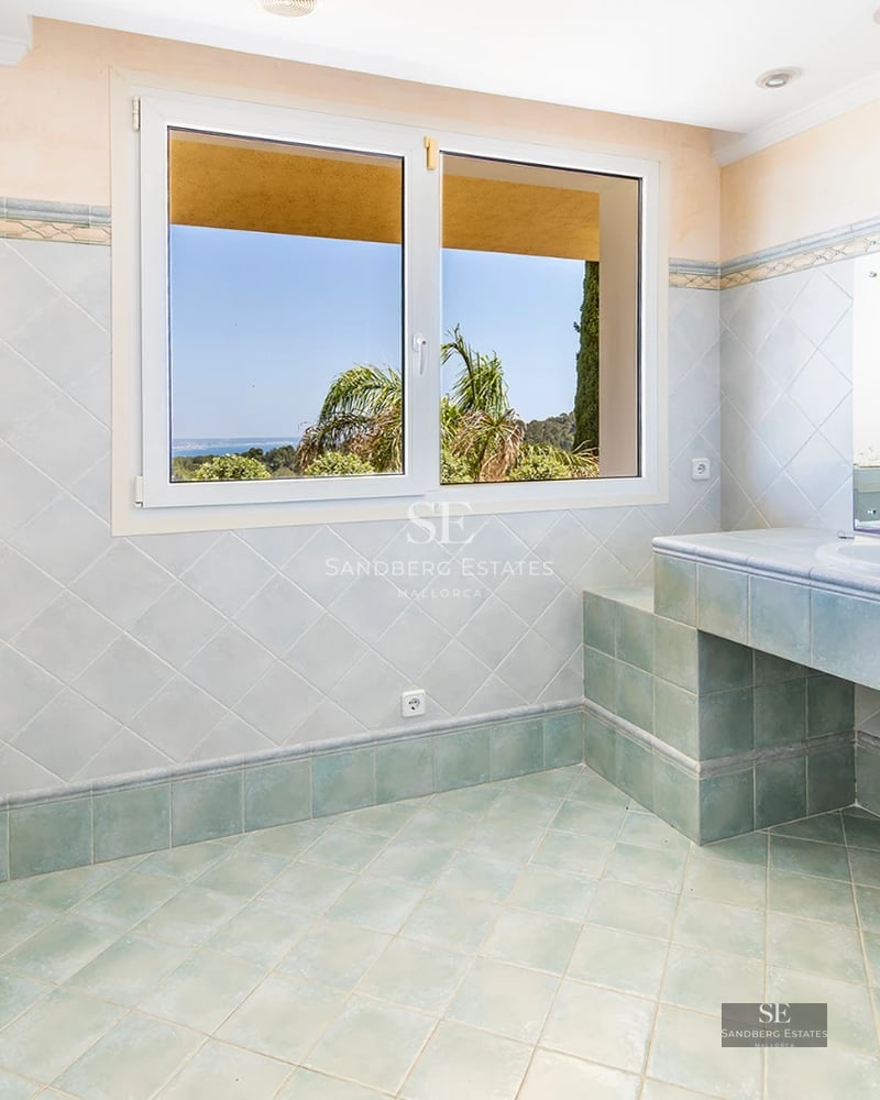 View of a luxurious villa featuring an infinity pool, lush garden, and modern architecture. Warm lighting and design details.