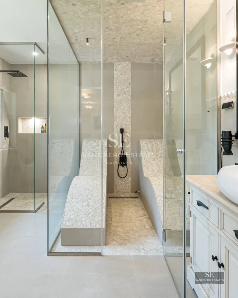 Large balcony with panoramic sea views. Modern design with glass railing and stylish furniture.