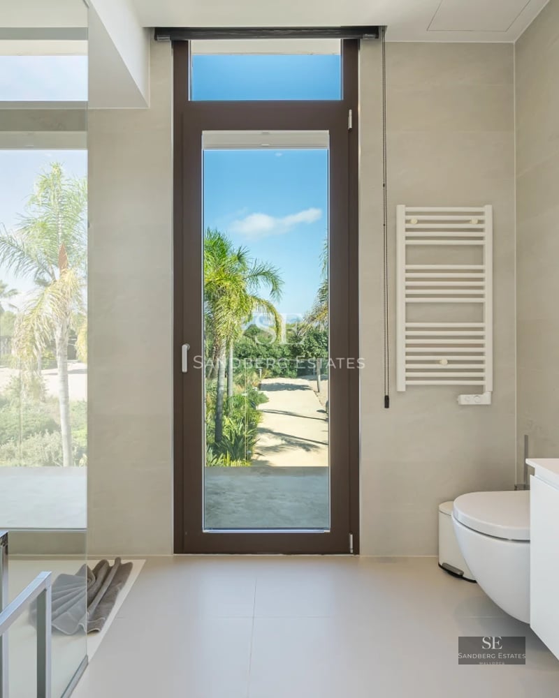 Spacious terrace with pool, sun loungers, and panoramic views. Modern architecture with large windows and minimalist design.