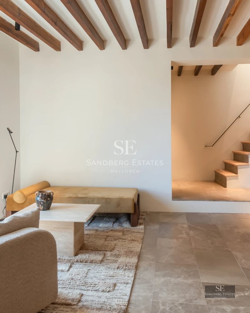 View of modern facade with infinity pool, lush vegetation and blue sky. Minimalist architecture. Stone cladding.