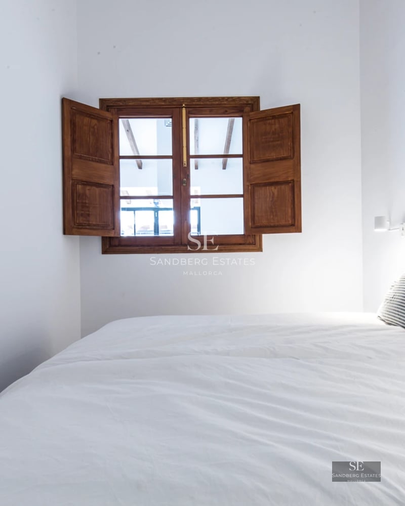 Balcony with glass railing, stunning landscape view, and modern furniture. Minimalist design featuring decorative plants.