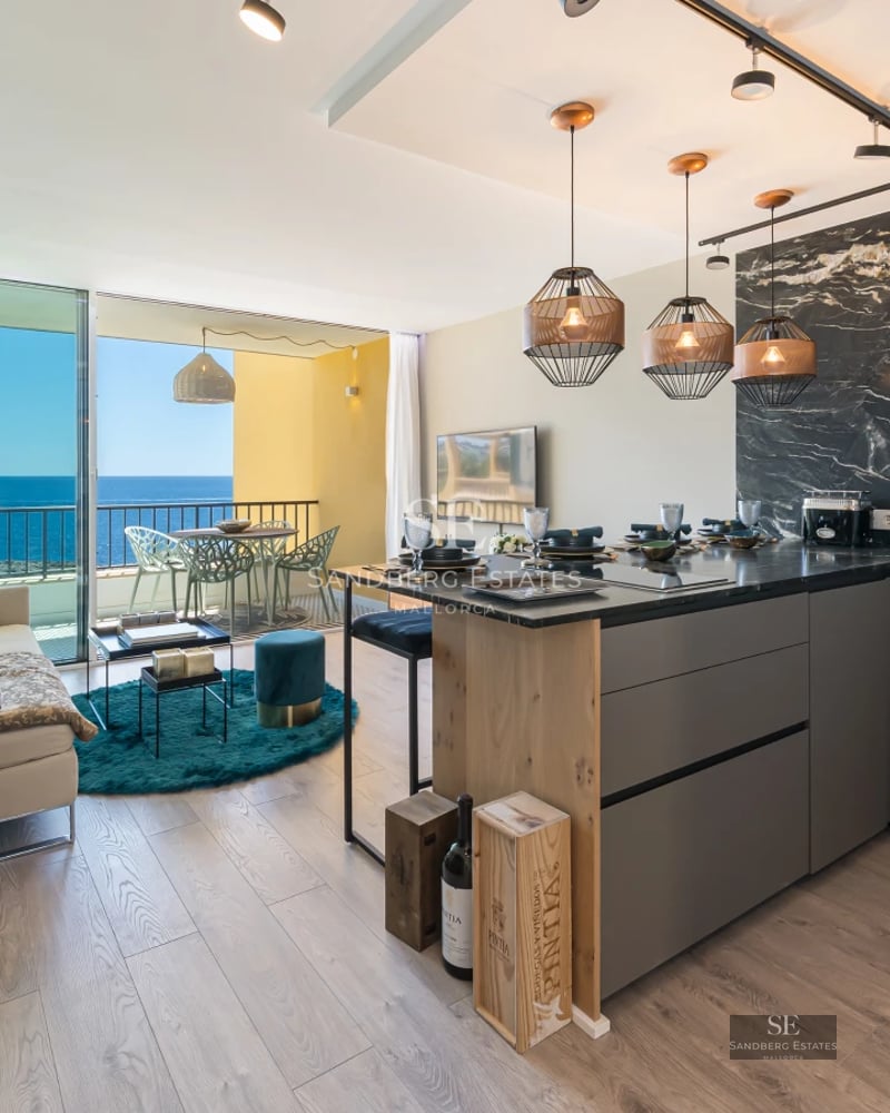 Exterior view of a modern villa featuring an infinity pool, lush garden, and panoramic sea views. Minimalist architecture.