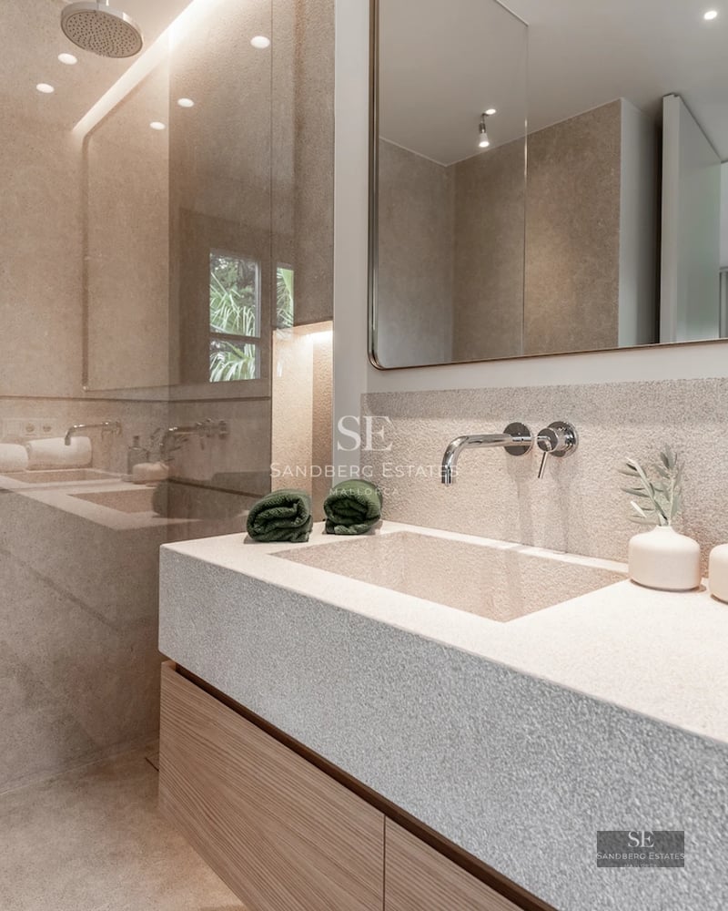 Spacious terrace featuring a pool, sun loungers, and views of a lush garden. Modern, minimalist architecture.