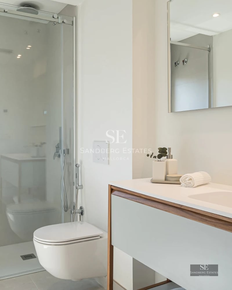 Exterior of modern villa featuring a pool, garden, and large windows maximizing natural light. Minimalist architecture and manicured landscaping.