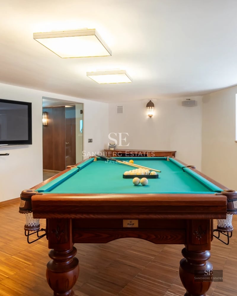 Panoramic view of a modern villa featuring a pool, lush garden, and spacious terraces. Cutting-edge architectural design with luxury finishes.