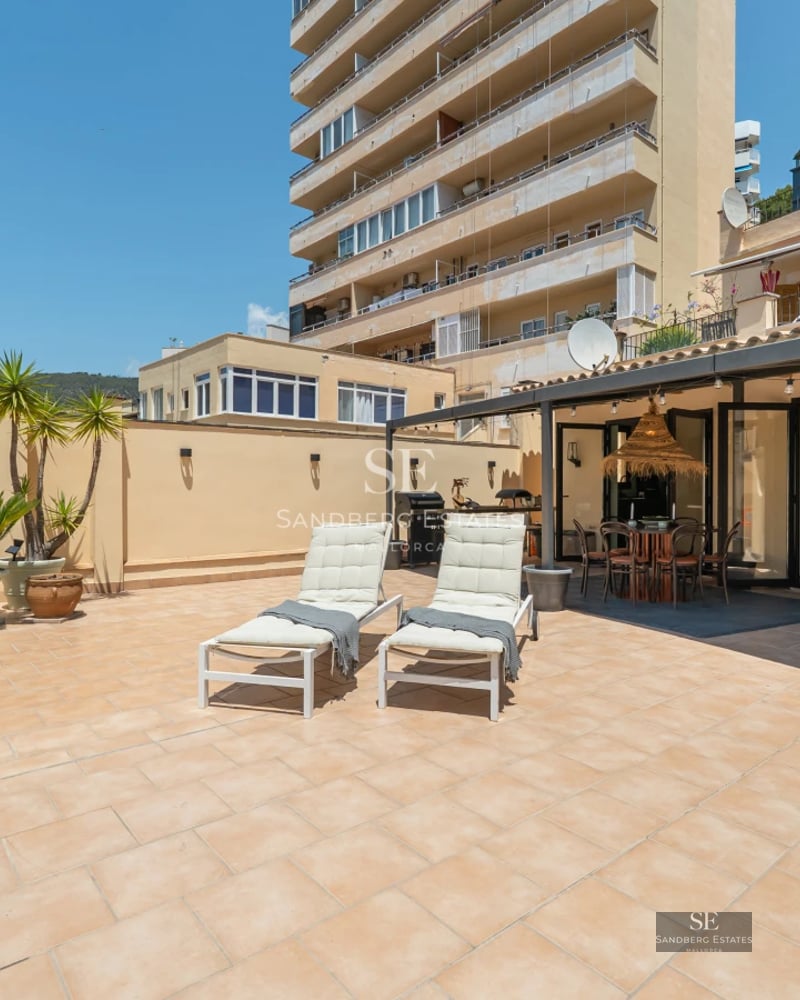 Exterior view of a luxurious villa with infinity pool, lush garden, and modern architecture. Warm sunset lighting.